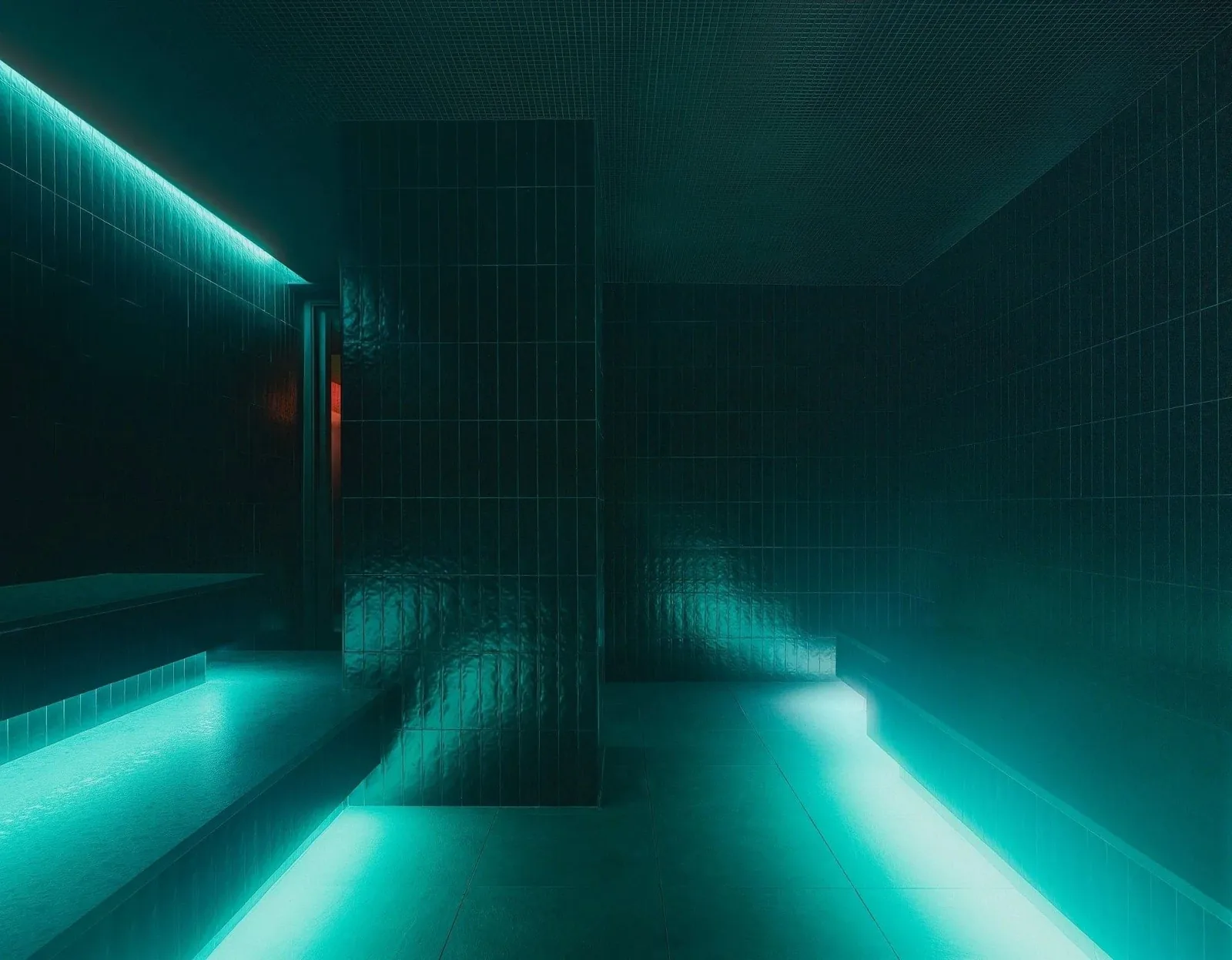Bathhouse Philadelphia steam room: dark glazed tile walls and benches with light along the bench edges